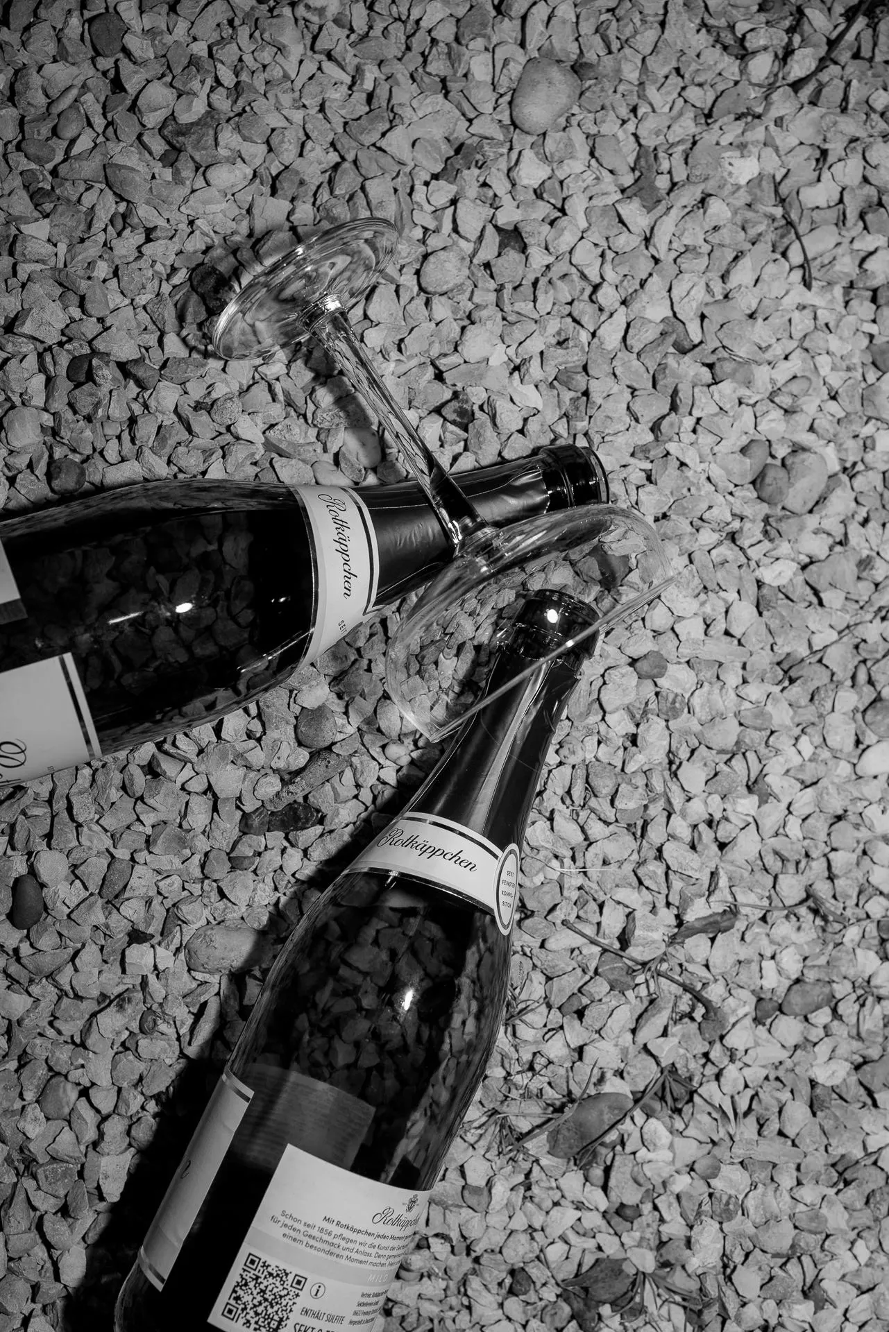 Black and white champagne bottles on gravel at luxury wedding at Chateau de Varennes in France